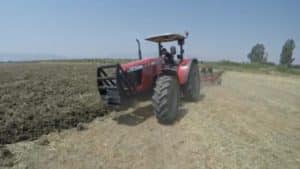 bush hog farm field with tractor